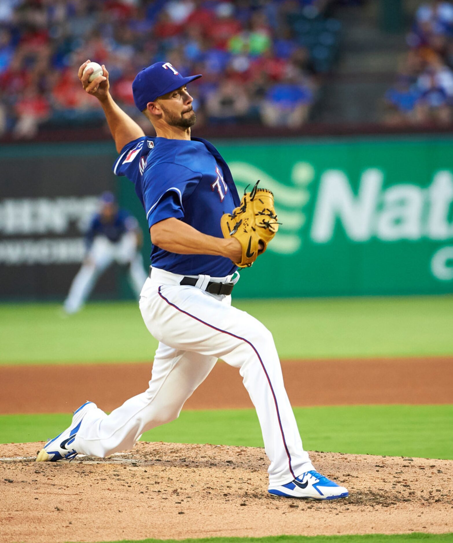 Texas Rangers' Mike Minor pitches to a Baltimore Orioles batter during the fourth inning of...