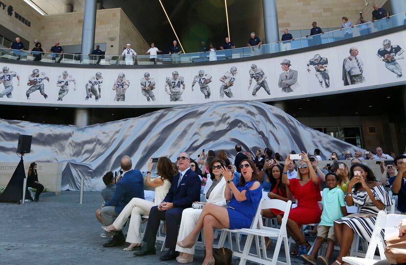 Dallas Cowboys Ring of Honor members unveil one side of the ring during the Ring of Honor...