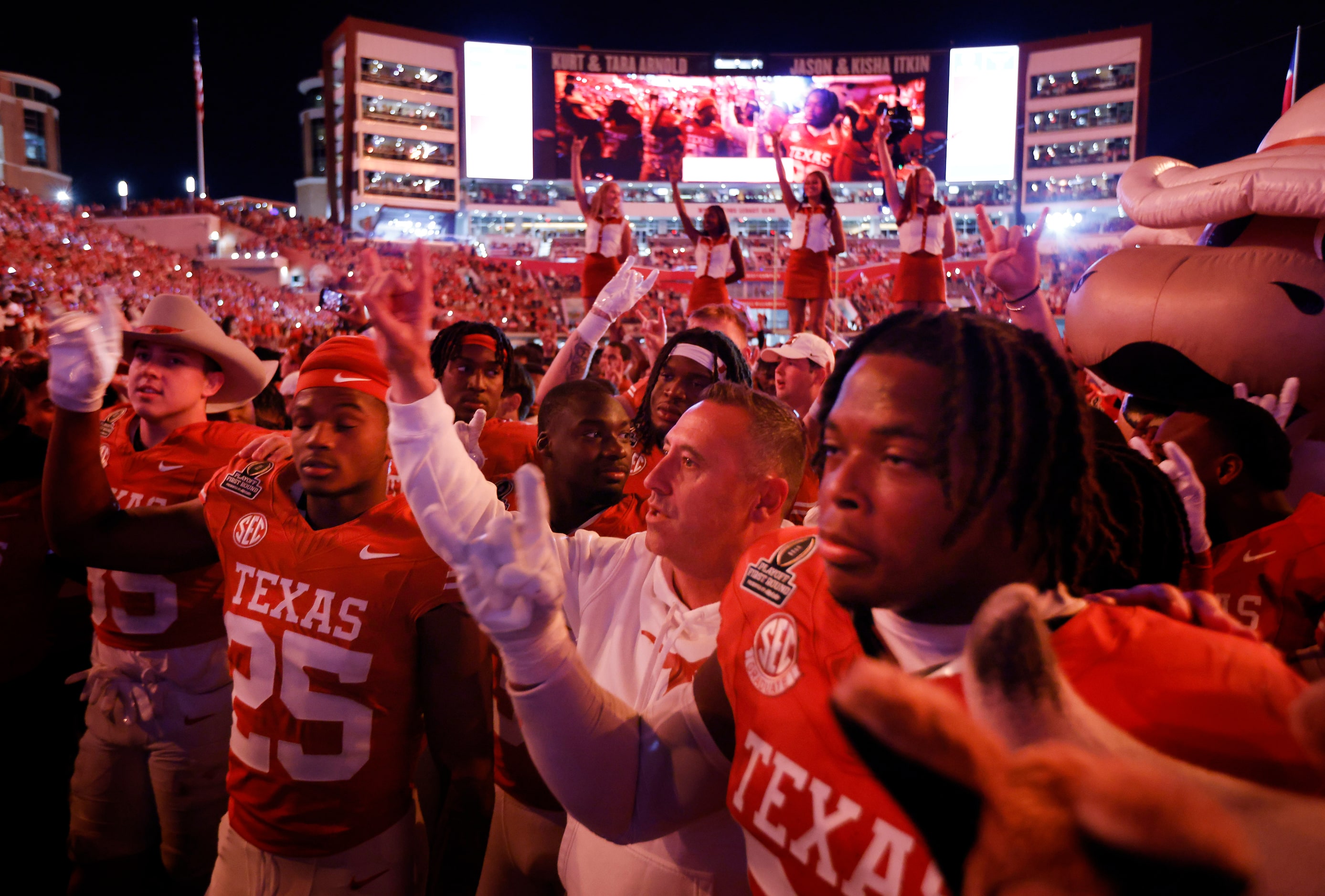 Texas Longhorns head coach Steve Sarkisian and his players sing the Eyes of Texas following...