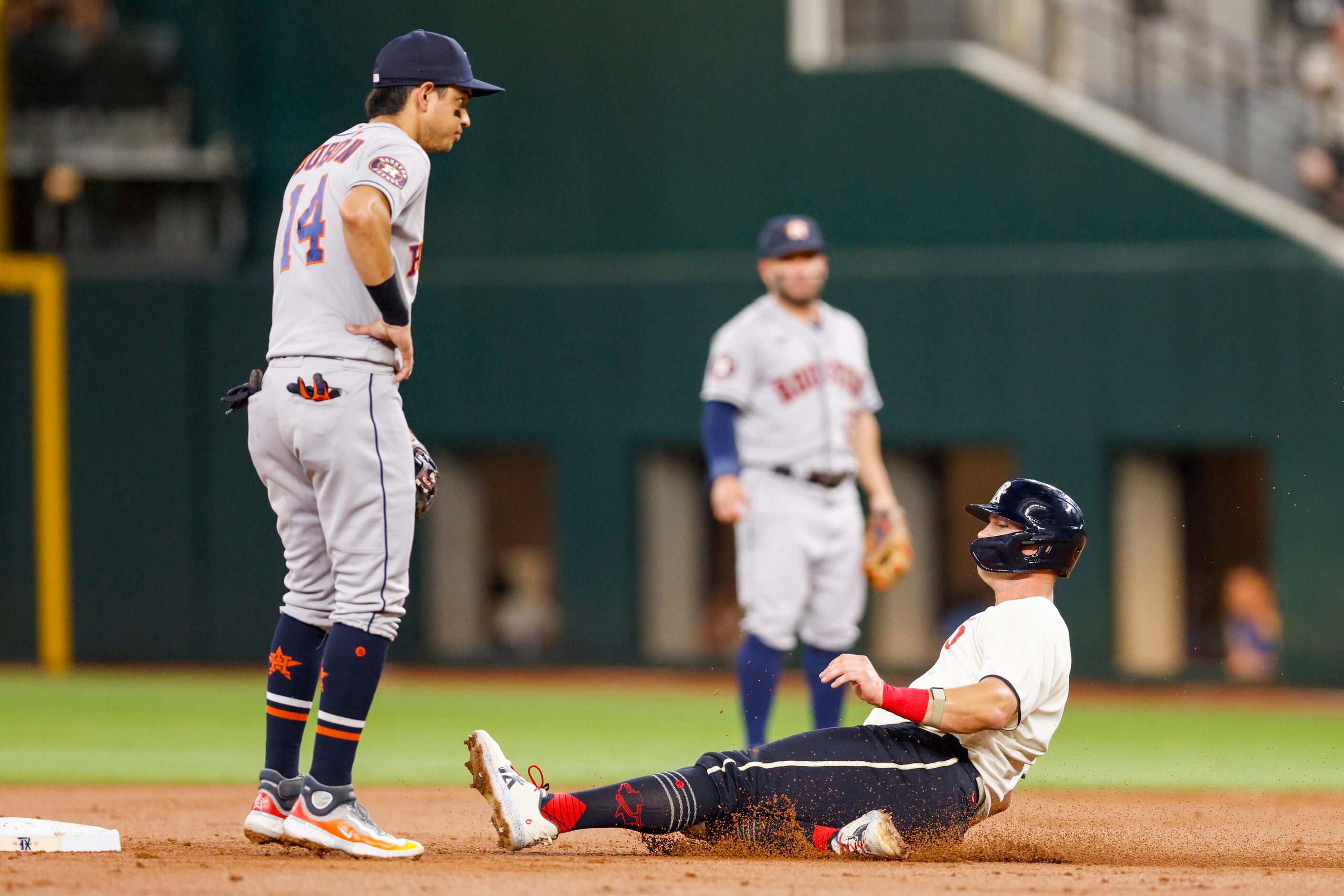 Texas Rangers third baseman Josh Jung (6) slides safely into second base ahead of Houston...