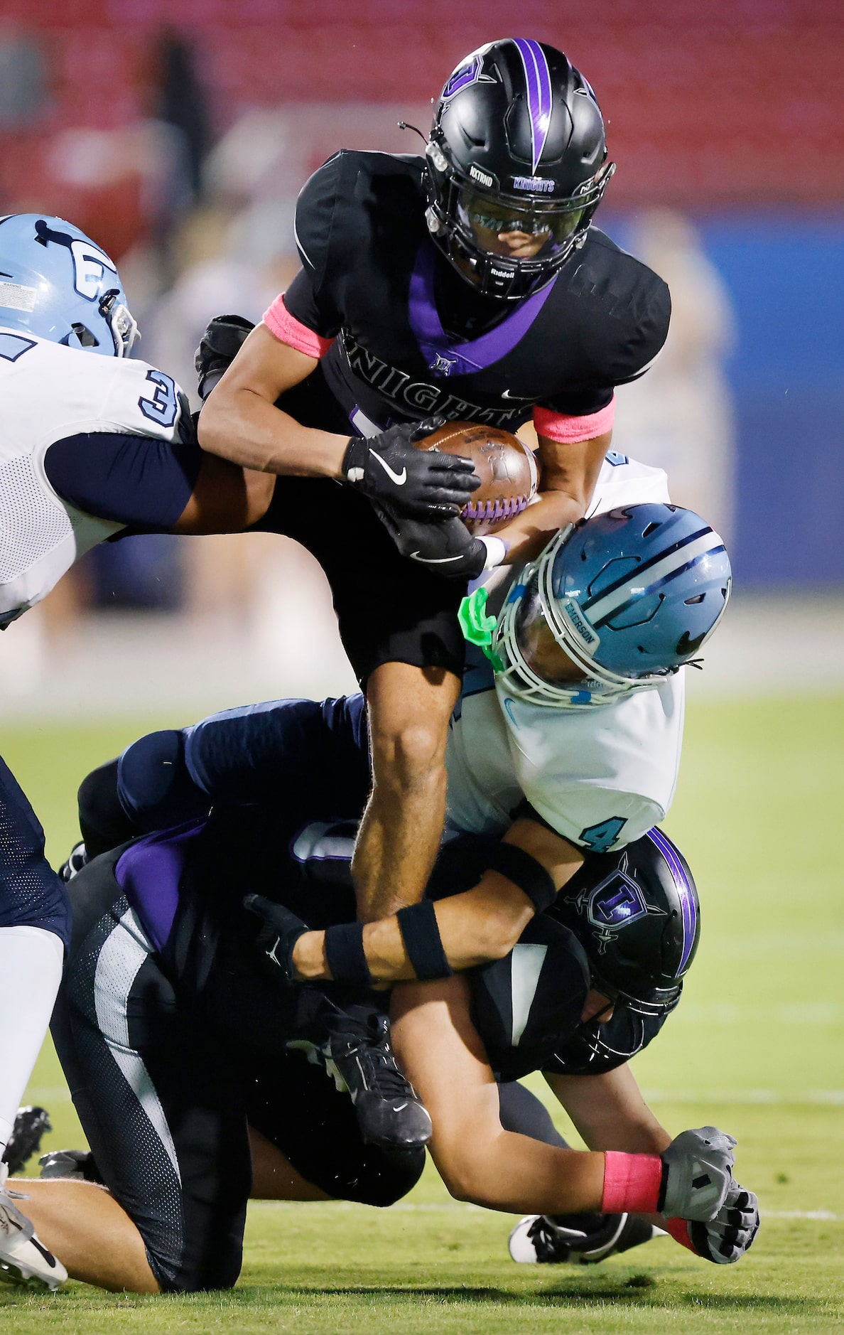 Frisco Independence running back Justin Lanham (3) is tackled in midair by Frisco Emerson...