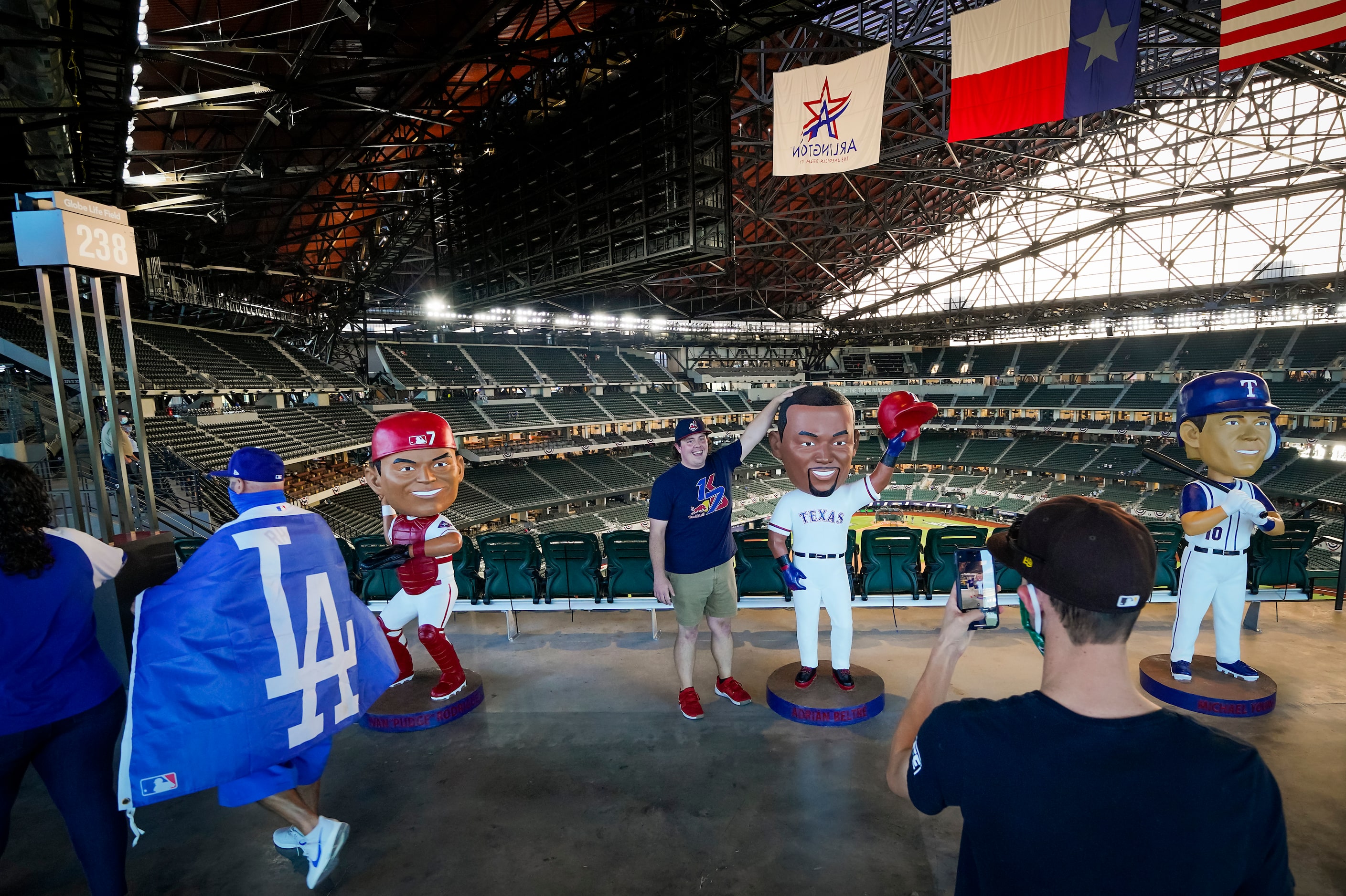 Fans checkout bobble head style statues of Texas Rangers greats Pudge Rodriguez, Adrian...