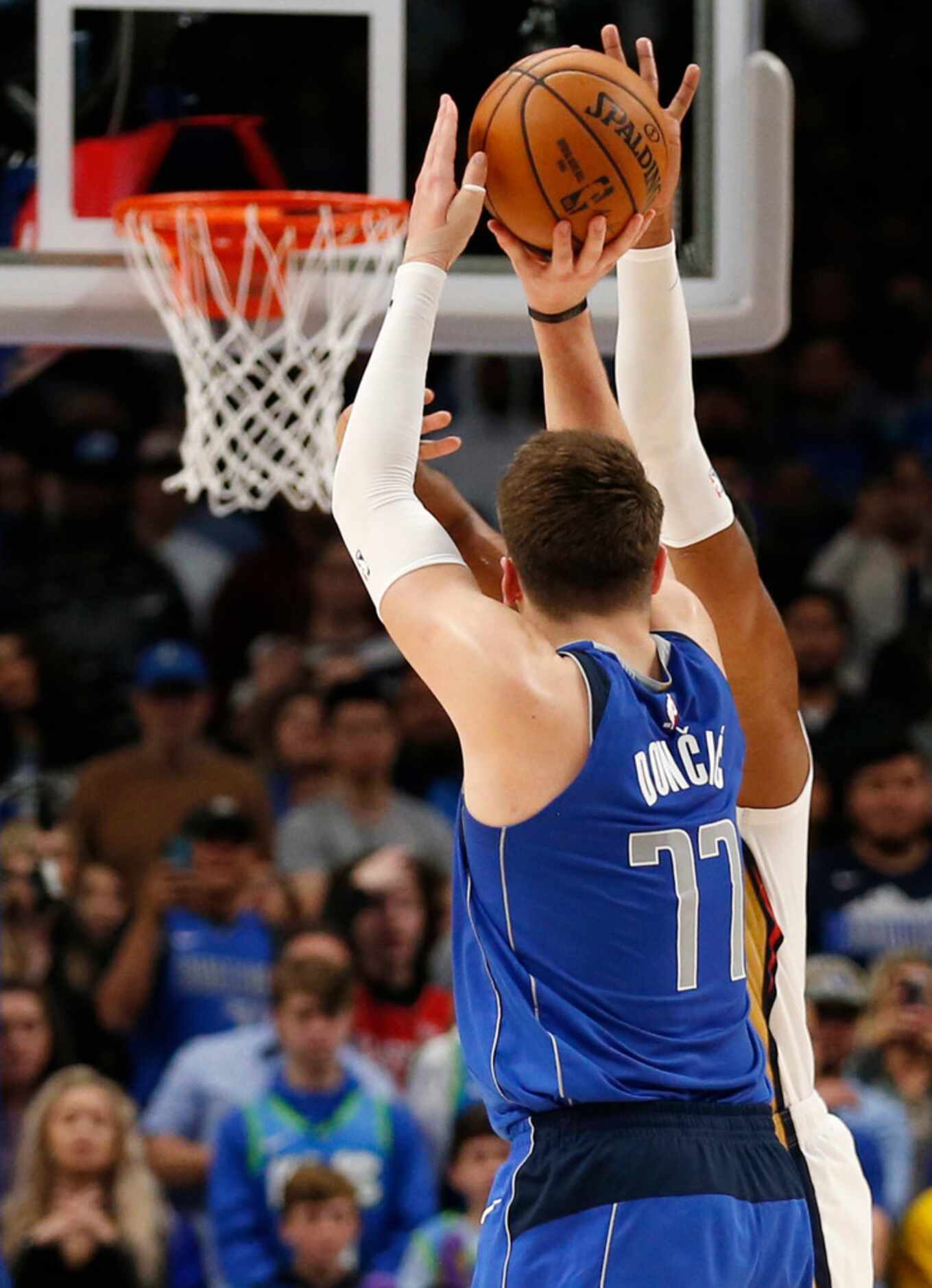 Dallas Mavericks guard Luka Doncic (77) shoots and makes a three pointer late in overtime...