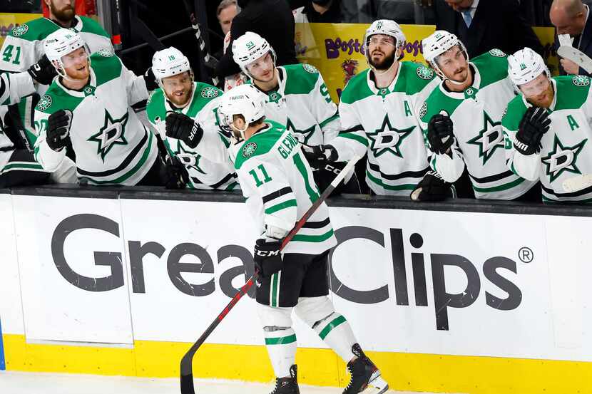 Dallas Stars center Luke Glendening (11) is congratulated by his teammates after scoring a...