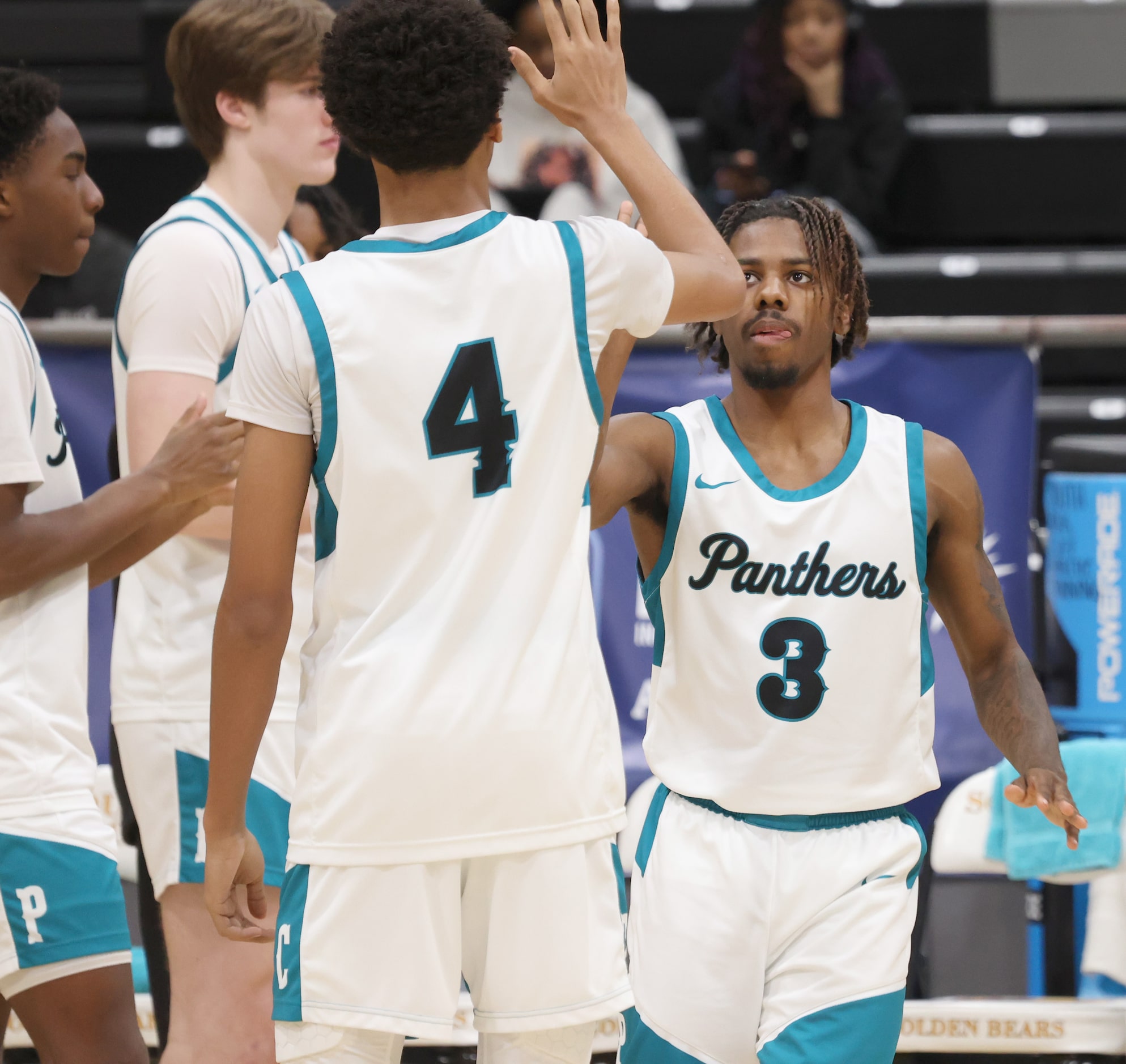 Frisco Panther Creek's KJ Whitehead (3), right, gives teammate Ked Cole (4) a "high five"...