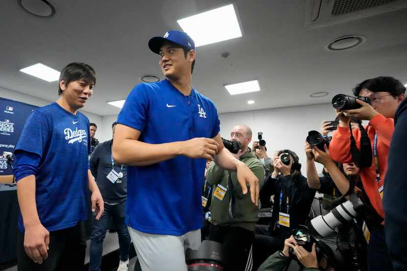 Los Angeles Dodgers' Shohei Ohtani, right, and his interpreter, Ippei Mizuhara, leave after...