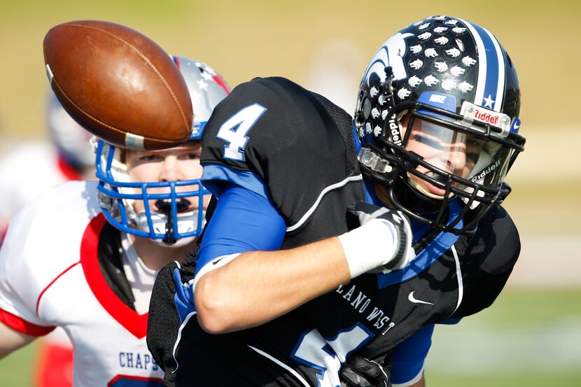 Plano West's Connor Doyle (4) loses the ball while being tackled by Austin Westlake's John...