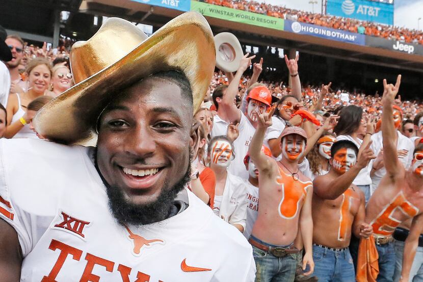 Texas Longhorns defensive back Kris Boyd (2) celebrates with fans with the traditional gold...