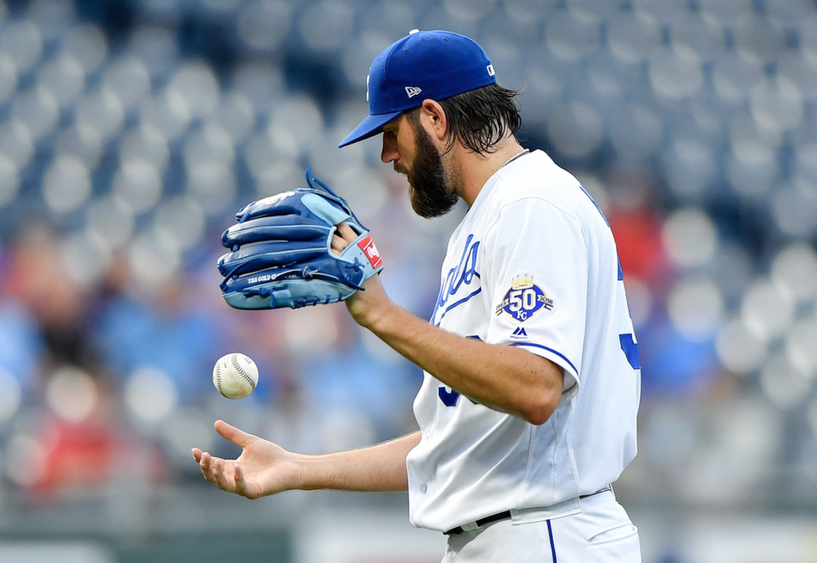 Kansas City Royals starting pitcher Jason Hammel tosses the ball around after giving up an...