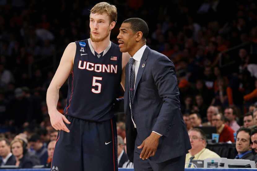 Connecticut's Niels Giffey, of Germany, and head coach Kevin Ollie talk during the second...