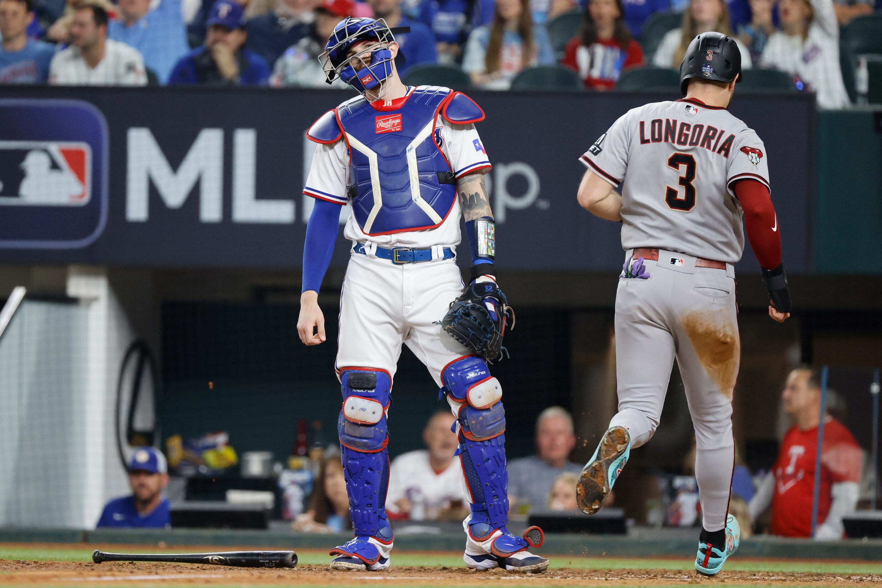 Texas Rangers catcher Jonah Heim reacts as Arizona Diamondbacks' Evan Longoria scores on a...