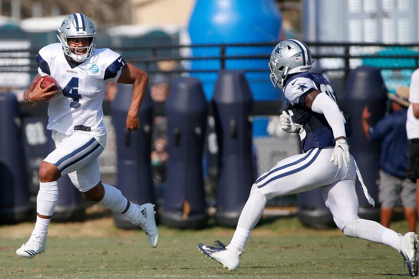 Dallas Cowboys quarterback Dak Prescott (4) runs past safety Xavier Woods (25) during the...