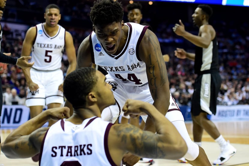 CHARLOTTE, NC - MARCH 16:  Robert Williams #44 celebrates with teammate TJ Starks #2 of the...