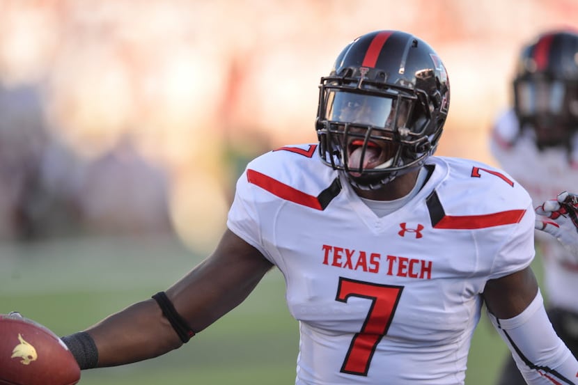 LUBBOCK, TX - SEPTEMBER 21: Will Smith #7 of the Texas Tech Red Raiders recovers a fumble...