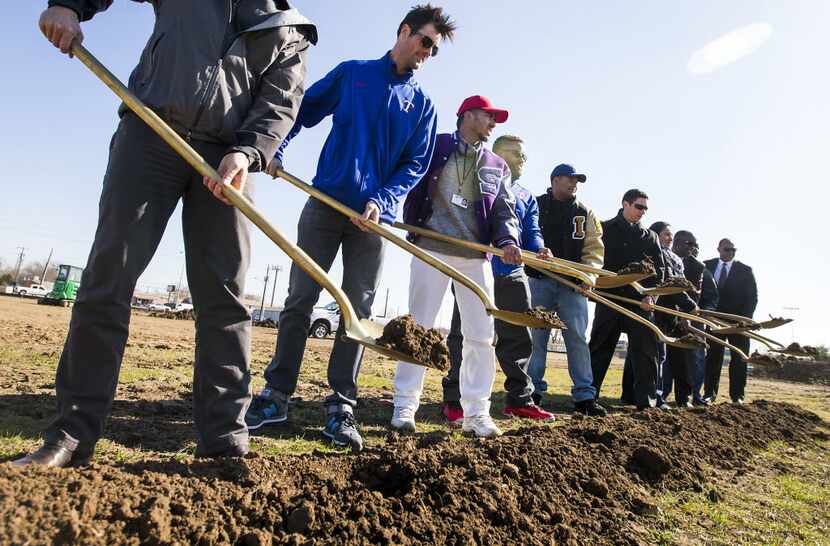 Texas Rangers pitcher Cole Hamels (second from left) joins youth player Jorge Guerra,...