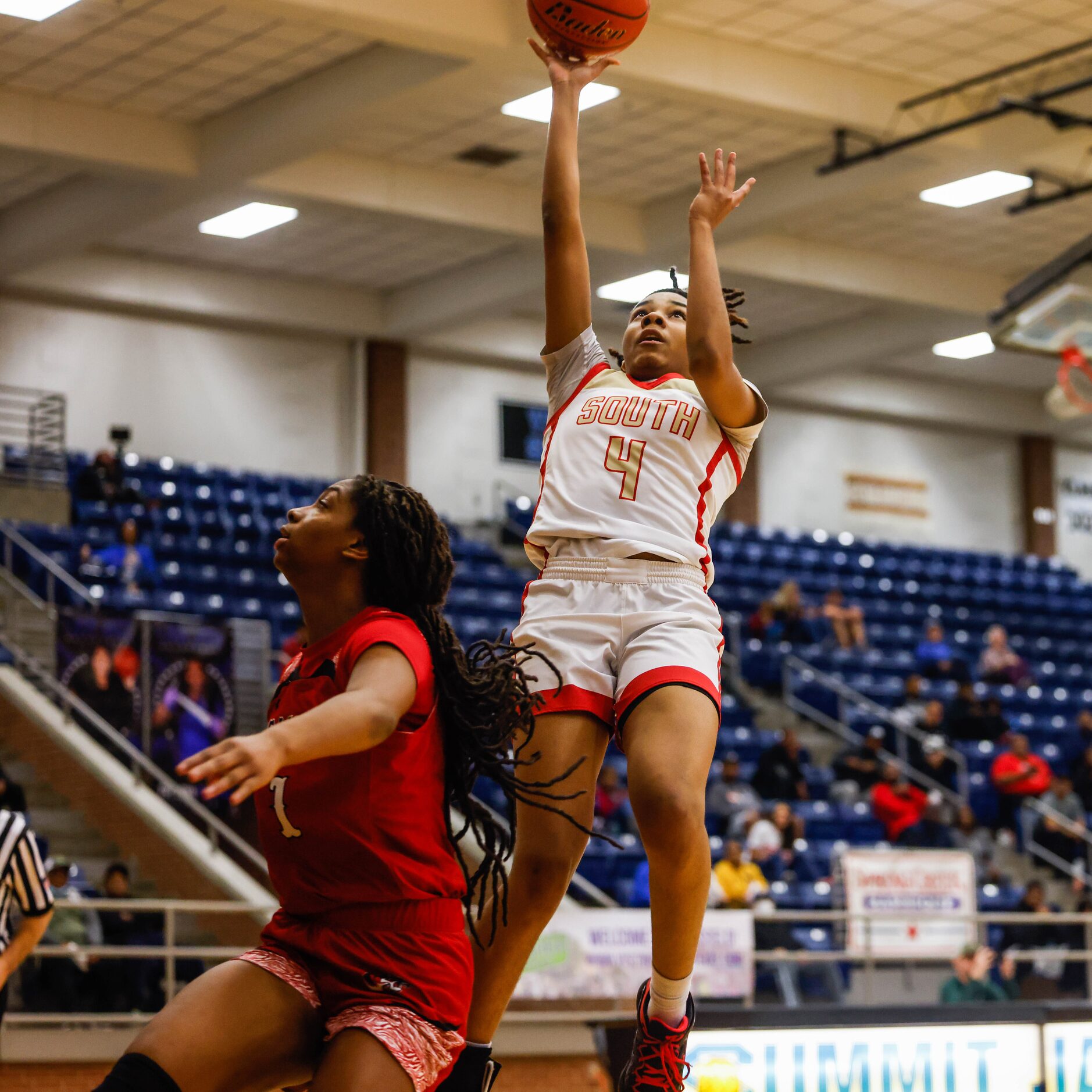 South Grand Prairie's Joy Madison-Key (4) goes for a shot againts Denton Braswell during the...