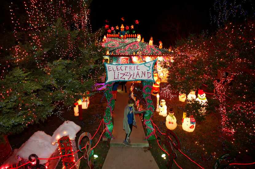 People tour the lights at Liz Simmons' house at 714 Newell Ave. in Old East Dallas.
