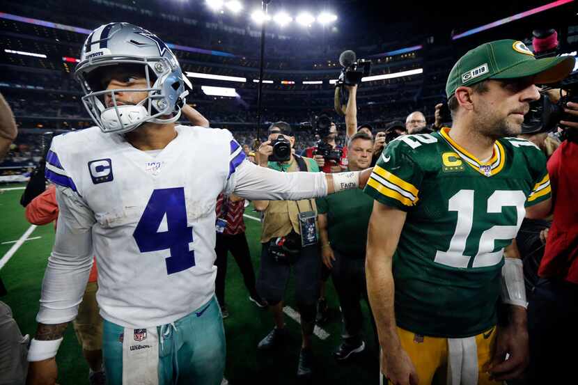 Cowboys quarterback Dak Prescott (4) congratulates Packers quarterback Aaron Rodgers (12)...