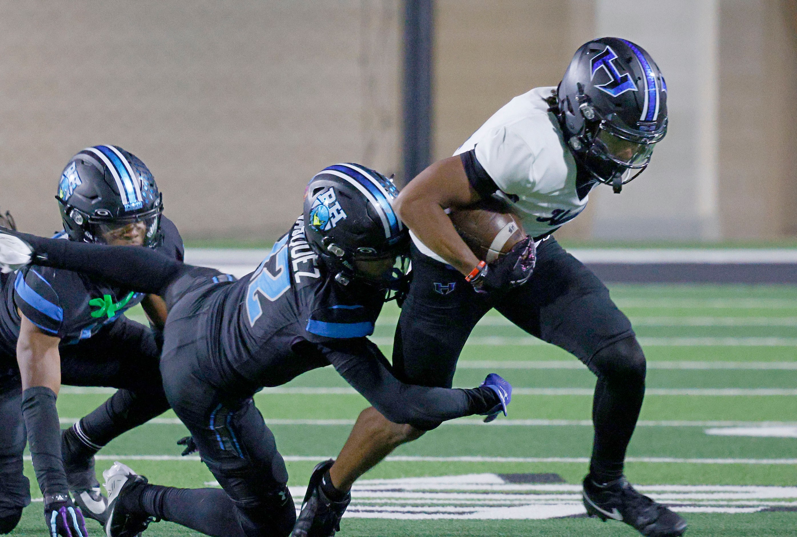 Hebron's Sheldon Armour (4), right, is tackled by Rock Hill's AJ Vasquez (12) and Rock...