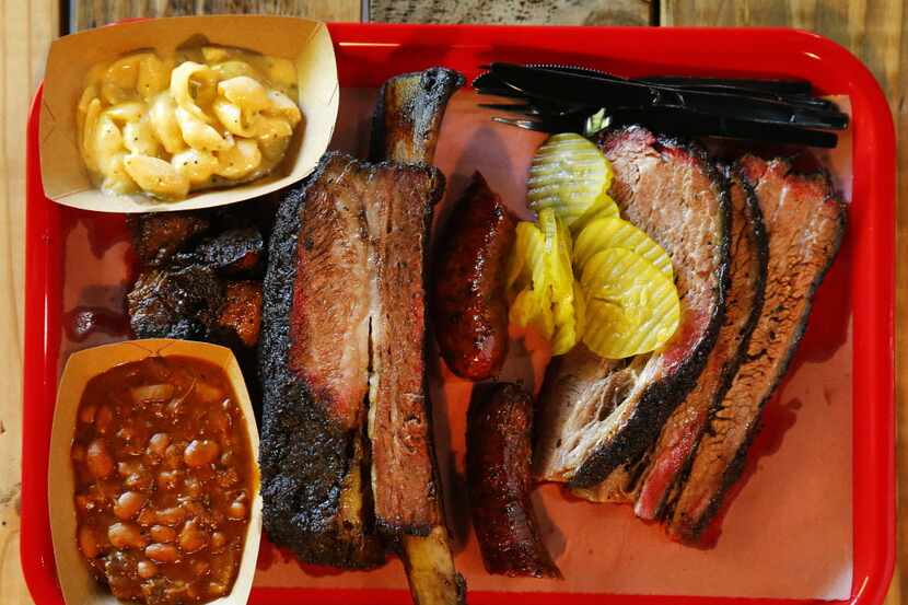 A tray full of burnt ends, brisket, beef rib, Texan spicy sausage, Italian sausage, burnt...