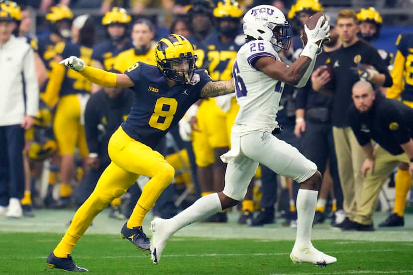 TCU safety Bud Clark (26) celebrate his intercepts a pass intended for Michigan wide...
