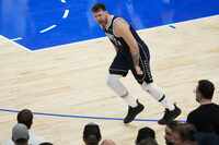 Dallas Mavericks guard Luka Doncic (77) celebrates after hitting a step-back jumper to give...
