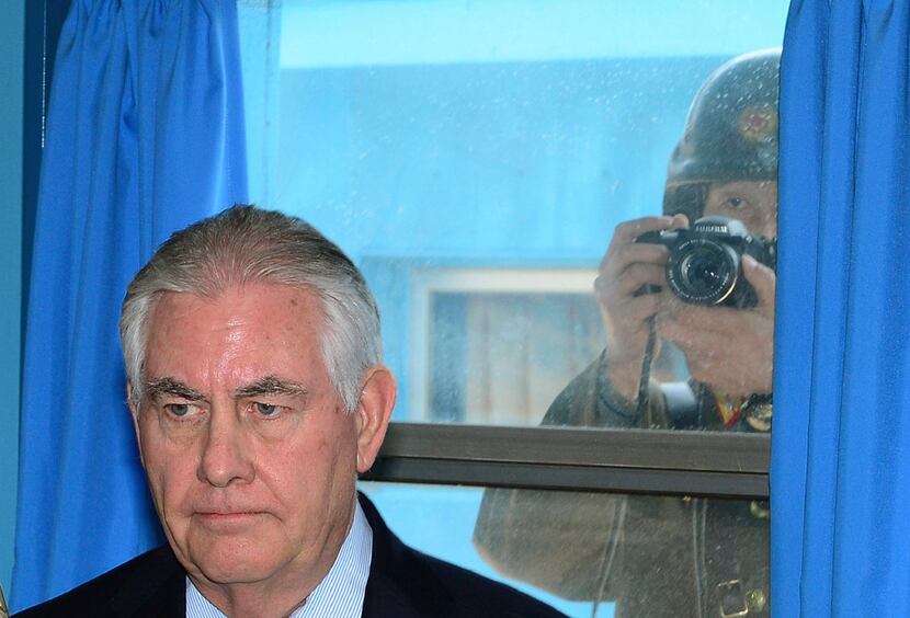 A North Korean soldier on Friday tries to take a photograph through a window while U.S....