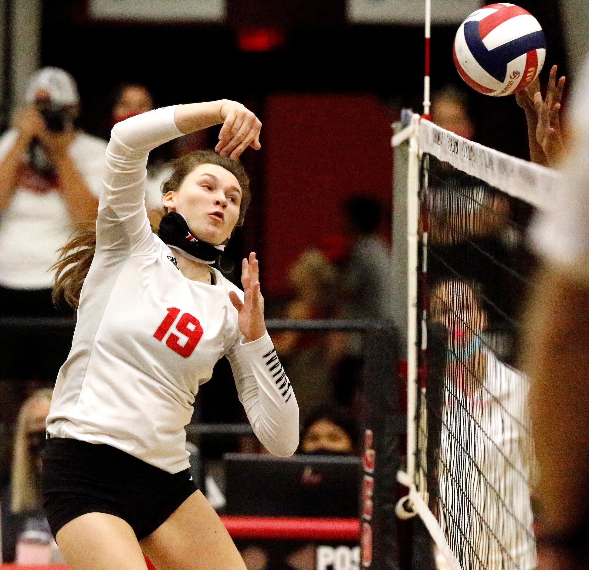 Lovejoy High School middle hitter Lexie Collins (19) makes a hit during game one as Lovejoy...