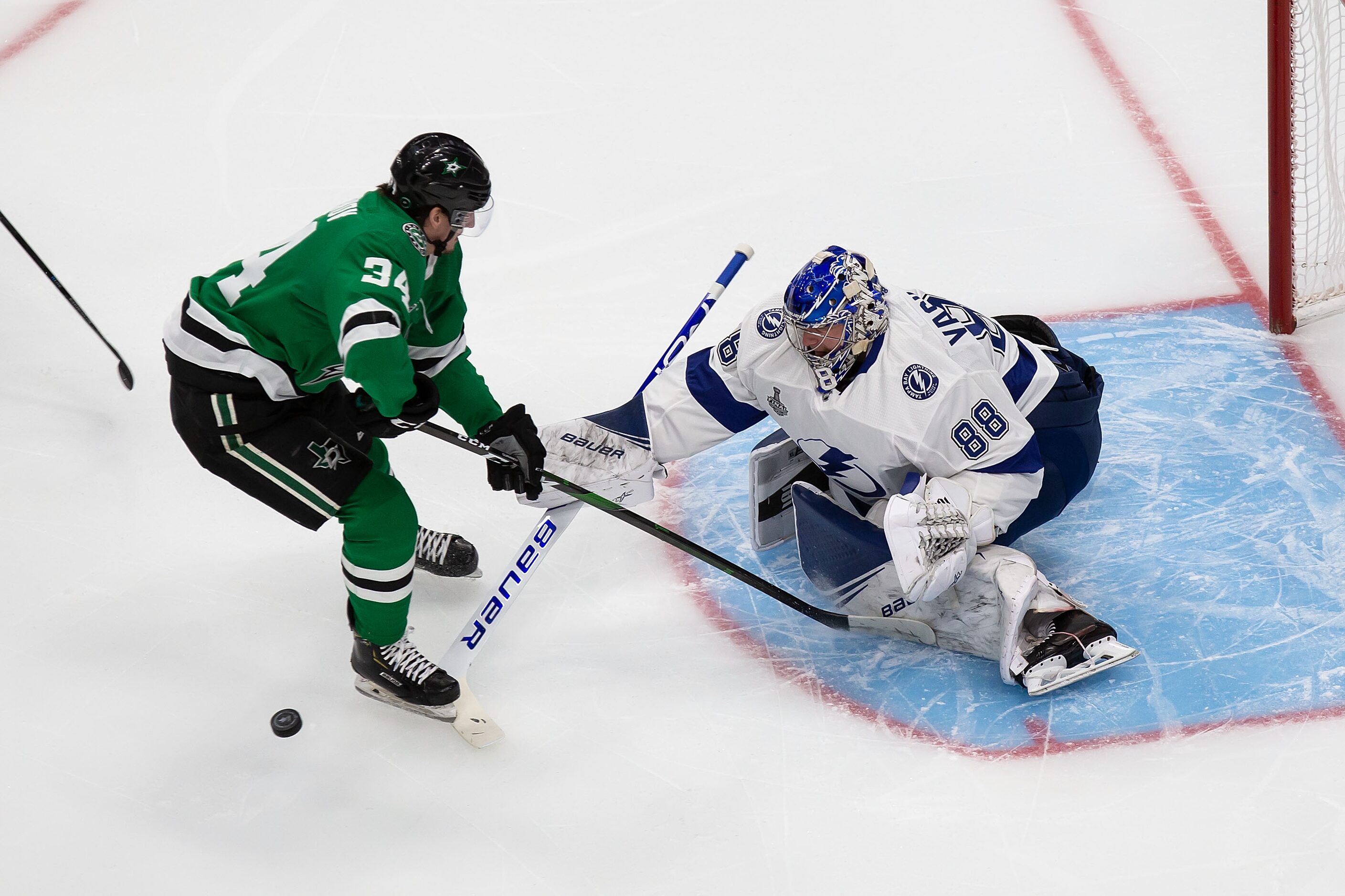 Denis Gurianov (34) of the Dallas Stars takes a shot against goaltender Andrei Vasilevskiy...