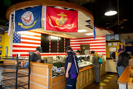 Customers stand in line at Patriot Sandwich Company on Feb. 18, 2020 in Denton. The shop...