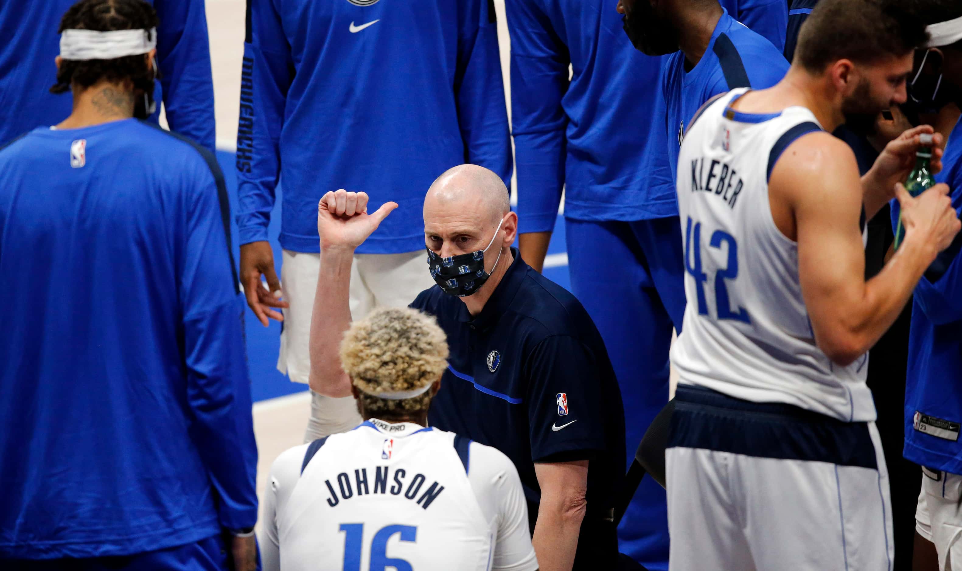 Dallas Mavericks head coach Rick Carlisle talks with his players during a timeout during the...