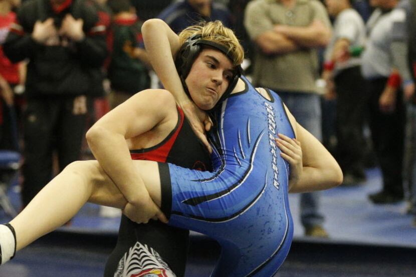 Euless Trinity's Mack Beggs (left) wrestles Grand Prarie's Kailyn Clay during the finals of...