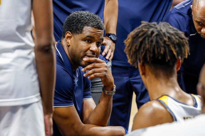 Oak Cliff Faith Family Academy head coach Brandon Thomas speaks to the team during a timeout...