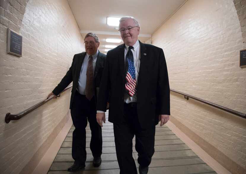 Texas Reps. Michael Burgess (left) and Joe Barton walk to a meeting with fellow House...