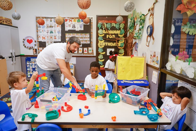 From left, Acel Cochran, teacher Charley Harris, Amari Ard and Joshua Hernandez play around...