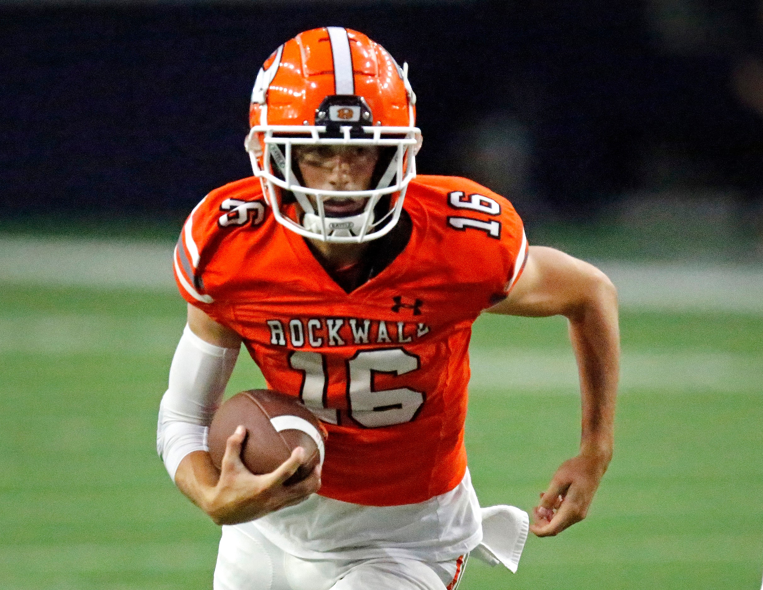 Rockwall High School quarterback Mason Marshall (16) looks for running room near the goal...