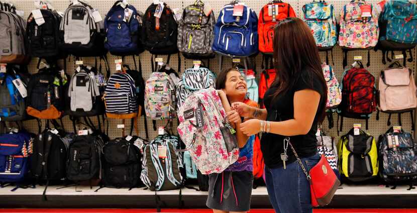 Back-to-School shoppers Tayde Salas, 9, pleads for her mother Cathy Salas to buy a pink...