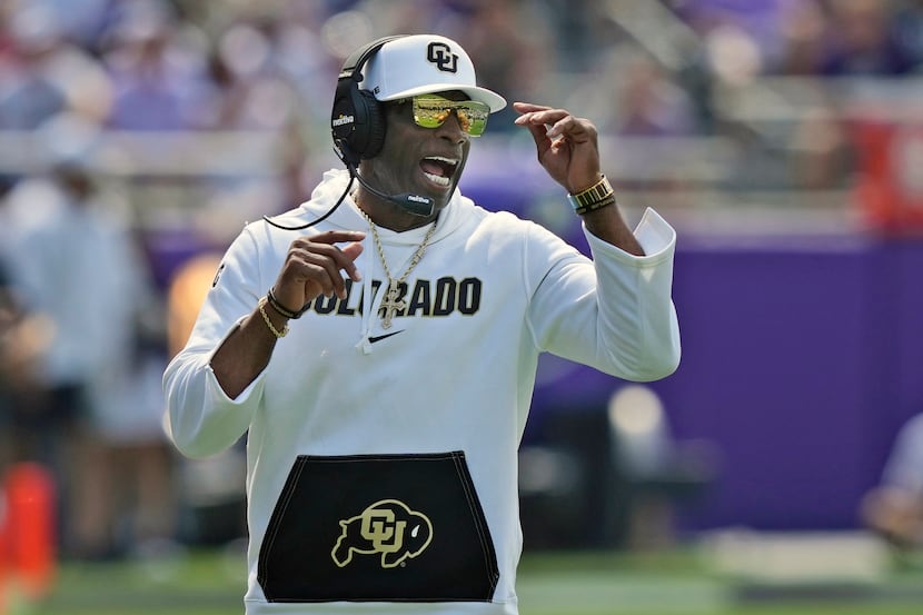 Colorado head coach Deion Sanders yells from the sidelines during the first half of an NCAA...