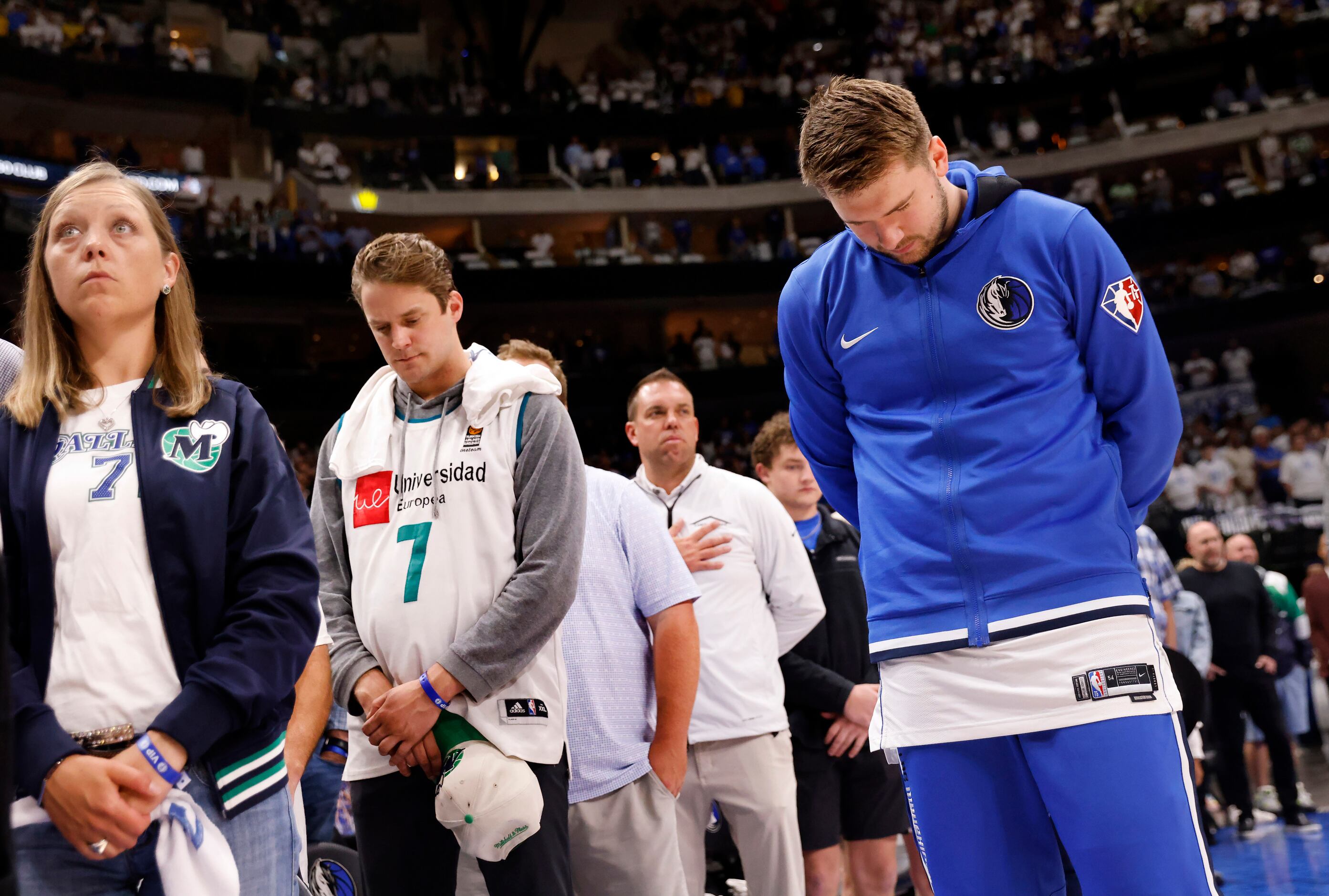 Dallas Mavericks guard Luka Doncic and fans bow their heads for a moment of silence for the...