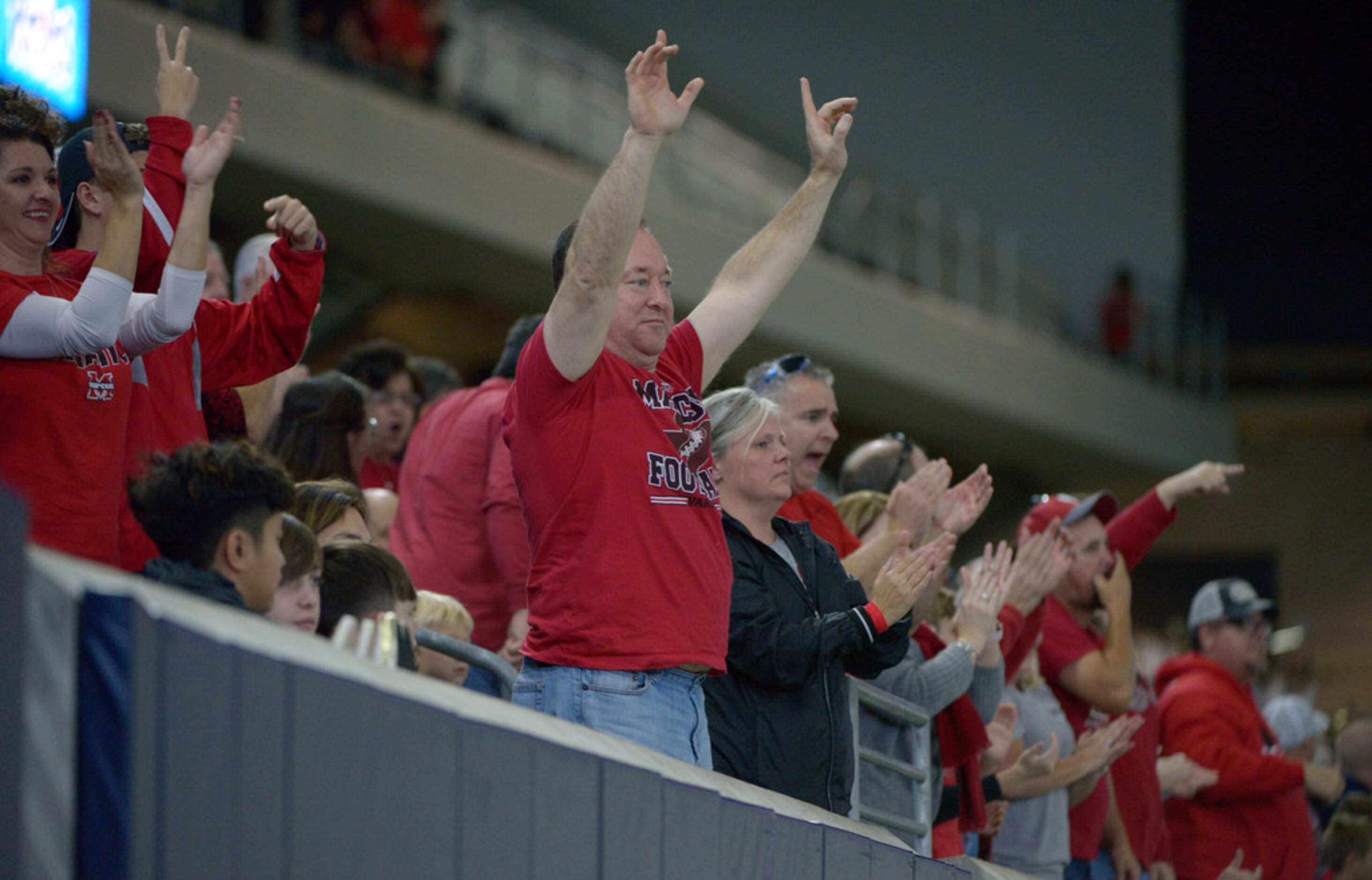 Flower Mound Marcus fans cheer after a 2-point conversion in the first half of a Class 6A...