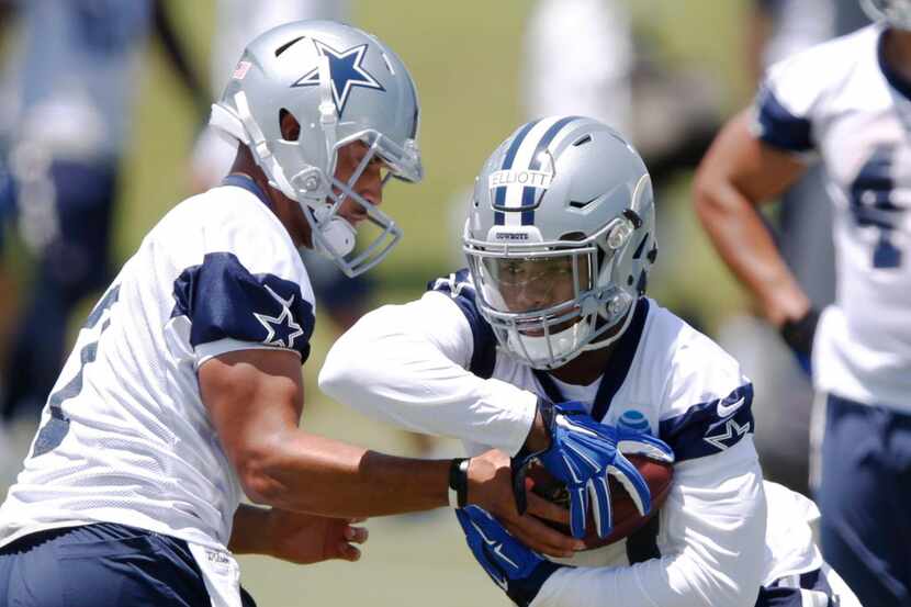 Dallas Cowboys quarterback Jameill Showers (7) hands the ball off to Dallas Cowboys running...