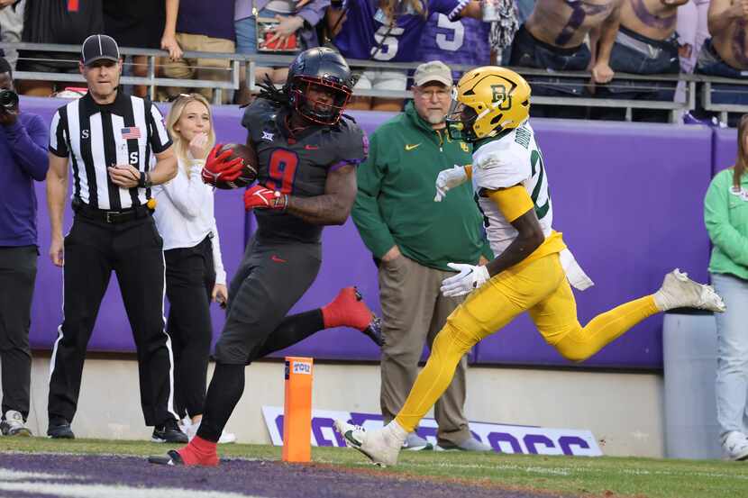 TCU running back Emani Bailey (9) scores past Baylor safety Devyn Bobby in the second half...