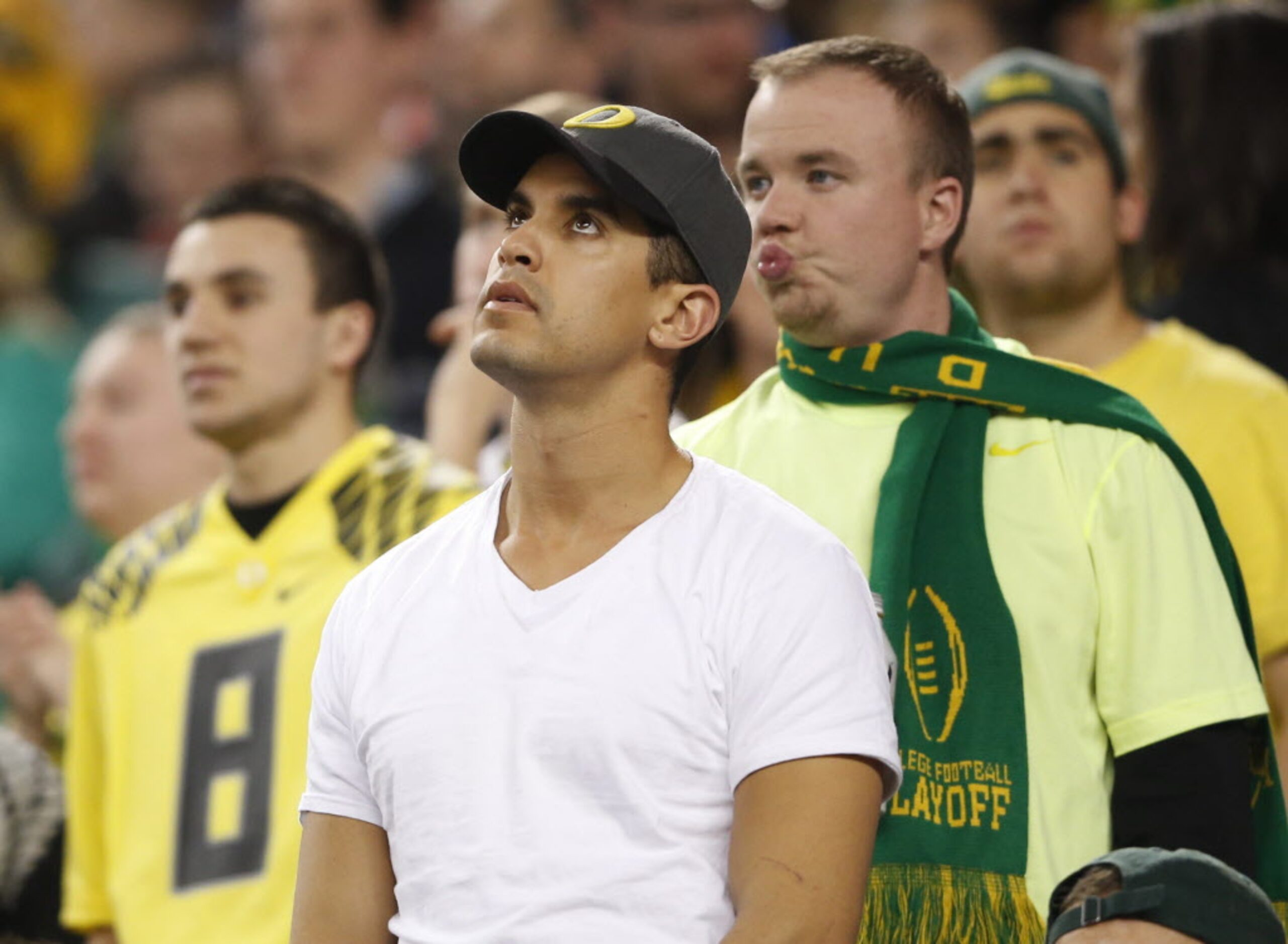 Dejected Oregon Ducks fans late in the second half of the College Football Playoff National...