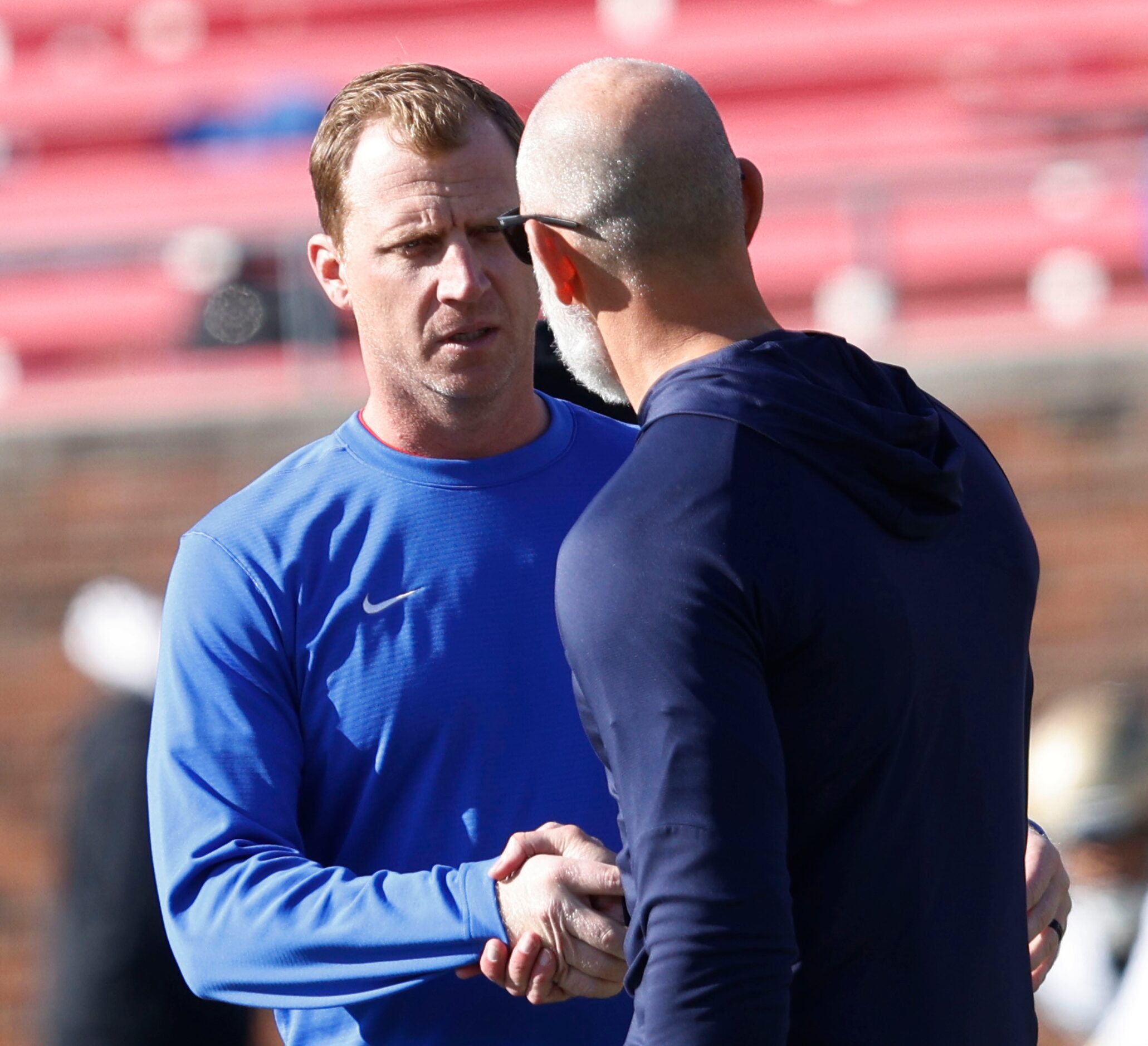 SMU head coach Rhett Lashlee shakes hands with Navy head coach Brian Newberry before an NCAA...