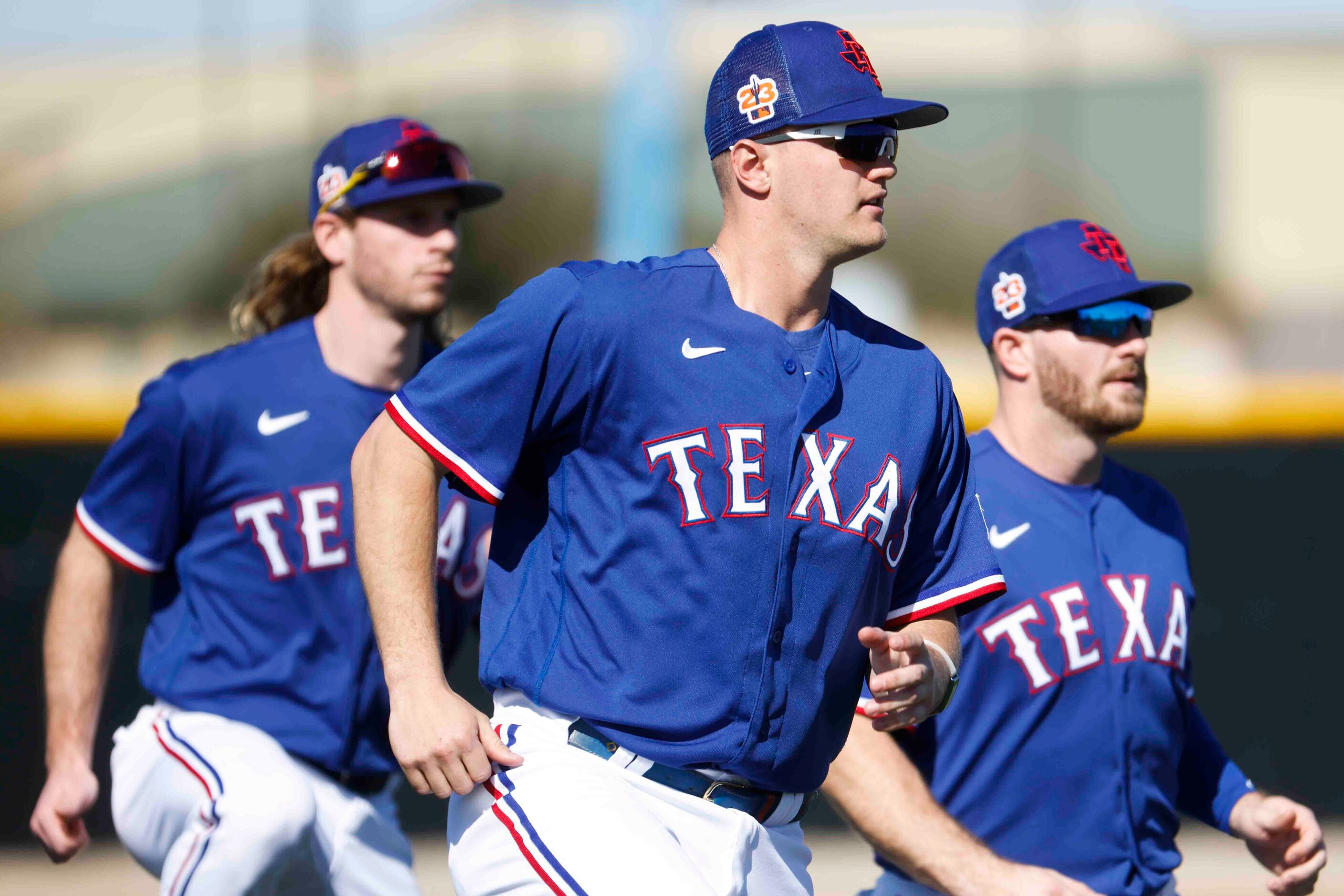 Texas Rangers outfielder Travis Jankowski, left, third baseman Josh Jung, center, and...