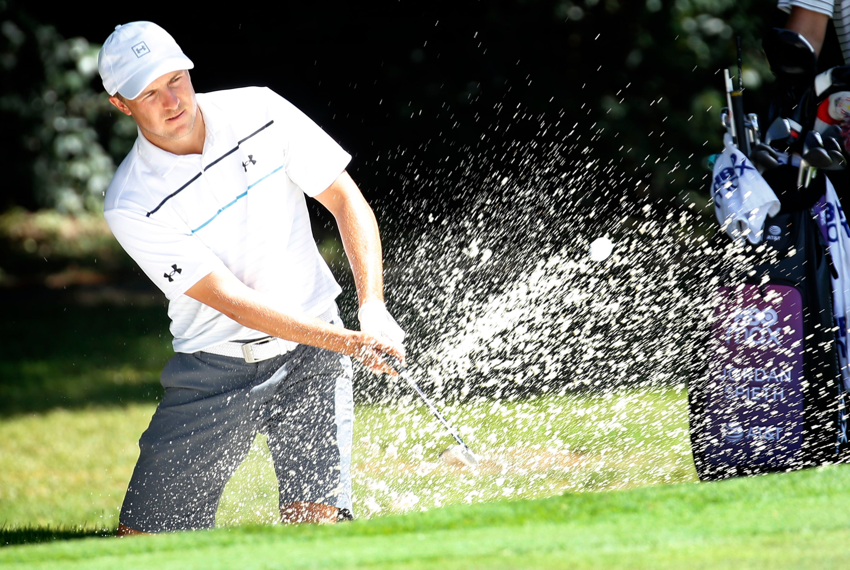 PGA golfer Jordan Spieth practices out of the No. 8 green side bunker during the Charles...