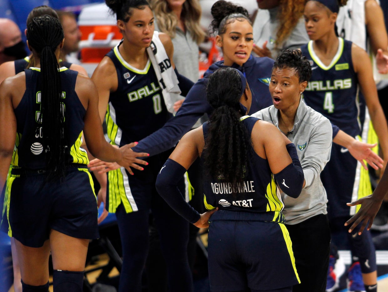 Dallas Wings head coach Vickie Johnson has a word with Wings guard Arike Ogunbowale (24) as...