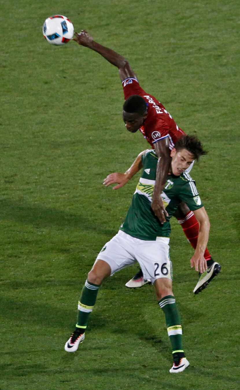 FC Dallas Maynor Figuerora (31) heads the ball over Portland's Lucas Melano (26) in the...