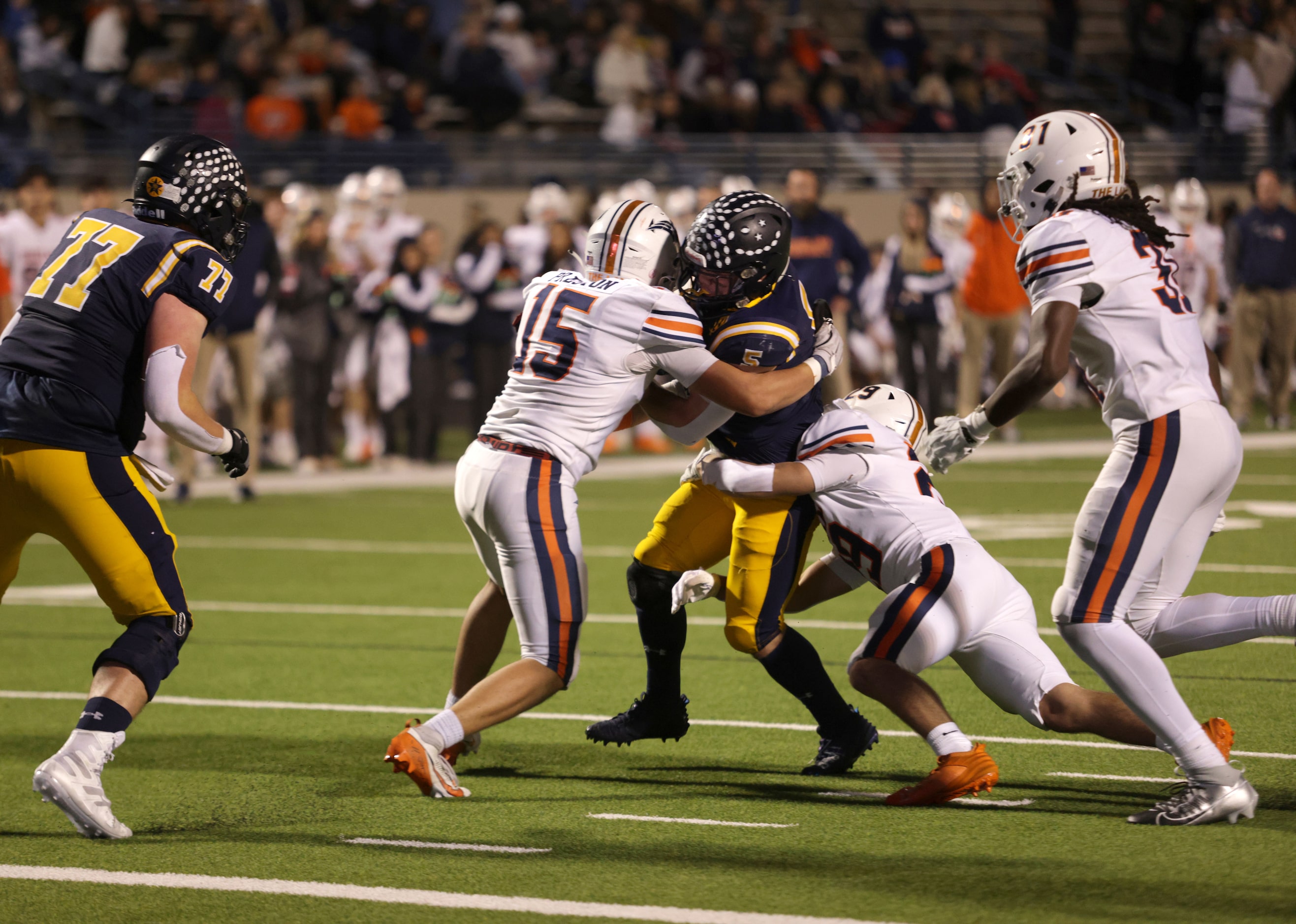 Highland Park running back James Lancaster gains some yardage before hitting a wall in a...