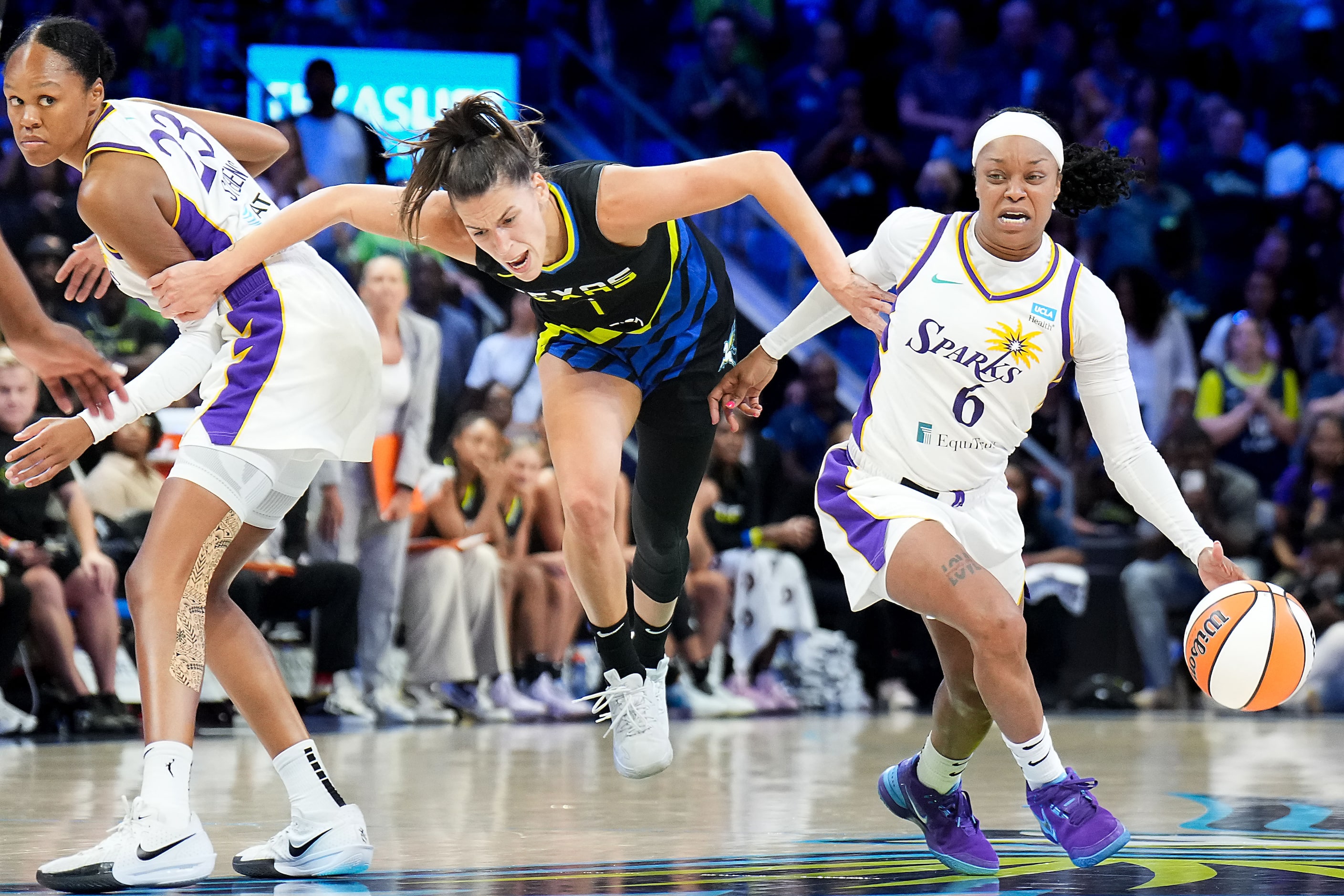 Dallas Wings guard Sevgi Uzun (1) is fouled by Los Angeles Sparks forward Azura Stevens (23)...